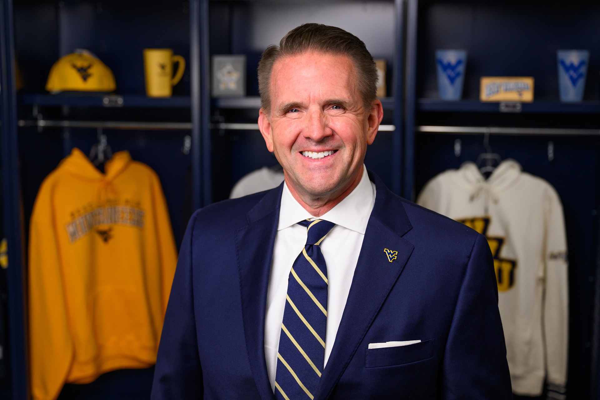 a portrait of President Michael T. Benson wearing a blue suit and flying WV pin